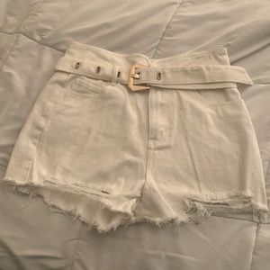 White jeans with gold and white belt.